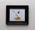 This artwork depicts a delicate glass bowl containing vibrant yellow flowers and a wooden honey dipper, alongside a...