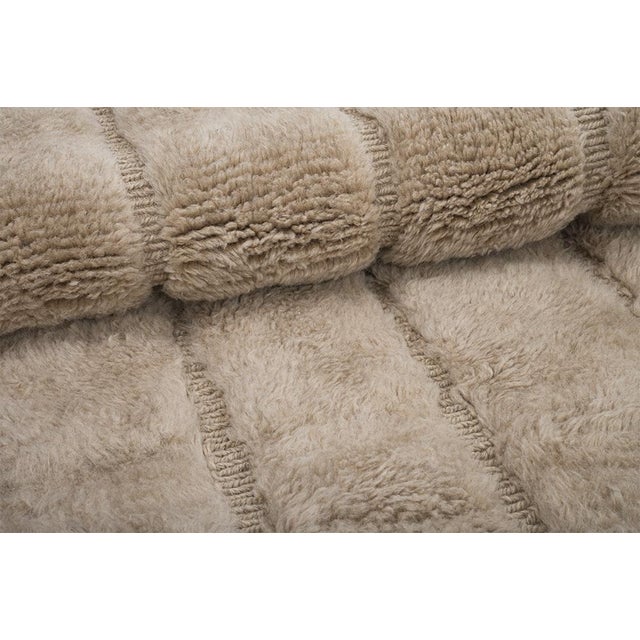 Timeless hand-knotted wool rug in warm Beige and Light Taupe, featuring a soft, layered geometric pattern with subtle...