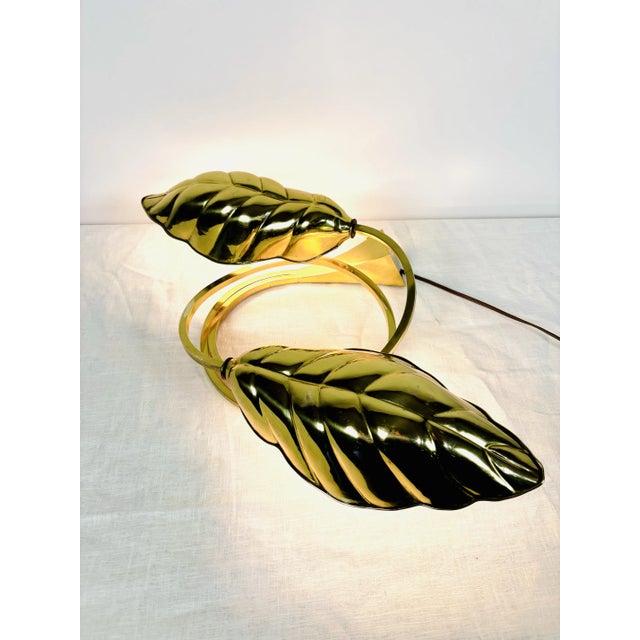 This stunning and marvelous Mid-Century Modern Italian lamp features a double leaf motif. The brilliant brass of the lamp...