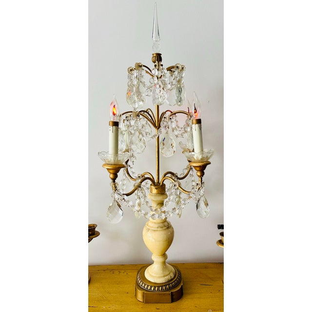 Stunning electrified candelabra/table lamp. Features four lights, many glass crystals, and beautiful pale yellow...