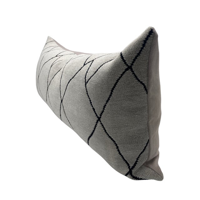 A handcrafted pillow fashioned with Mokum Berba in Platinum fabric on the front and backed in a flax colored linen....