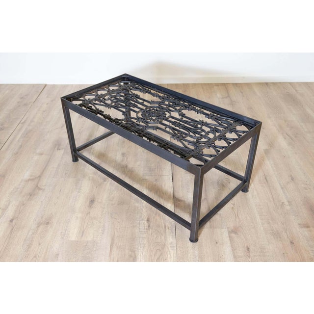 This unique coffee table repurposes antique French balcony railings into a striking piece of functional art. The tabletop...