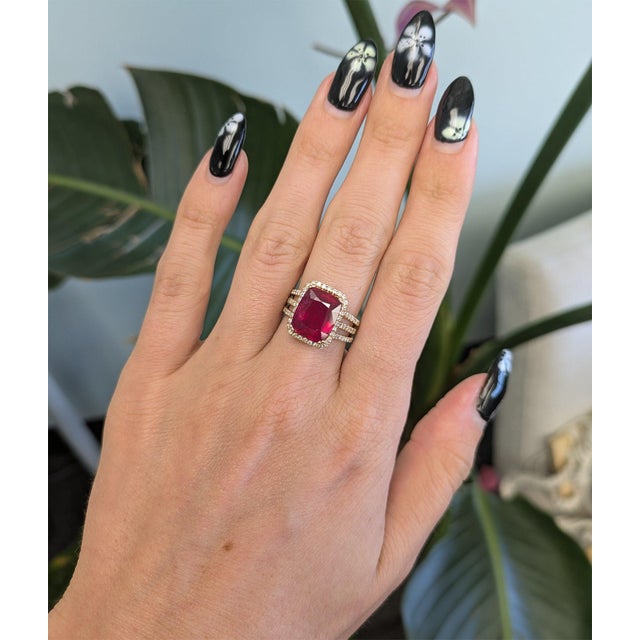 A remarkable 7.66-carat Madagascar ruby anchors this solid 14K yellow gold ring, encircled by ninety-two earth-mined...