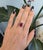 A remarkable 7.66-carat Madagascar ruby anchors this solid 14K yellow gold ring, encircled by ninety-two earth-mined...