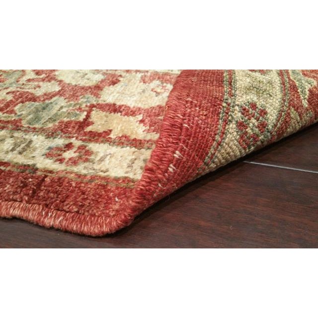 This beautiful runner is handmade knotted. It is a vintage rug made of fine wool in beautiful colors of red, beige, green....