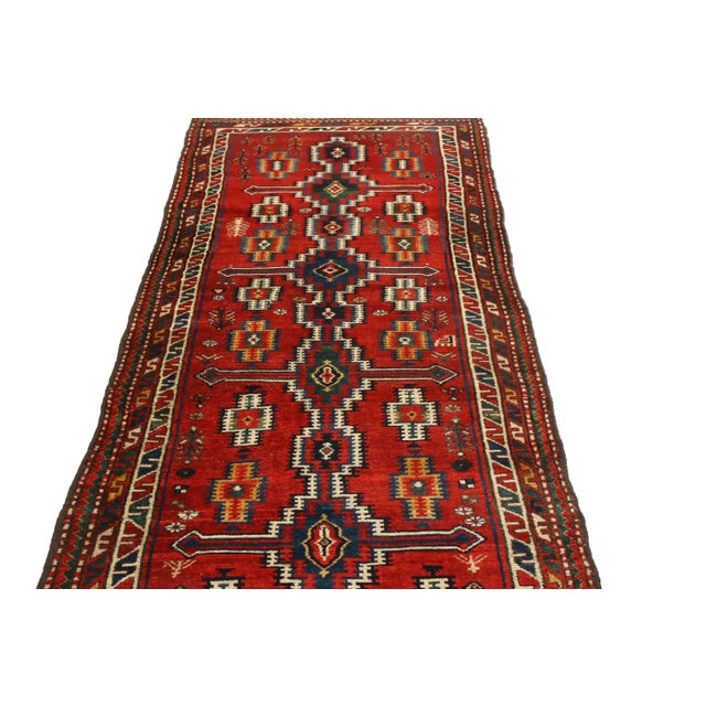 Originating from Persia in 1880, this antique Persian runner features a Northwest design, denoting a varied, traveled...