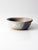 Vintage handmade studio pottery bowl with a warm speckled glaze accented by a broad wash of lavender-blue. The gently...