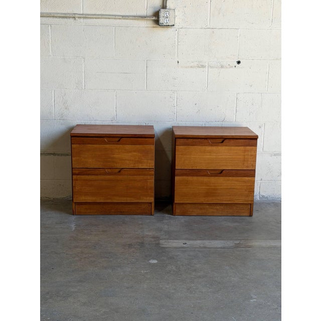 This matching pair of nightstands features a clean block silhouette with deep storage compartments. The streamlined design...