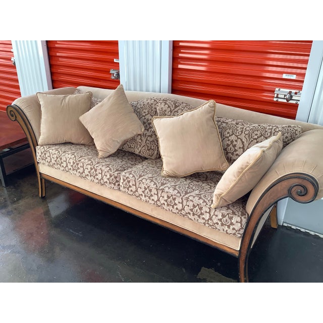 This style of sofa represents traditional American or European furniture design popular from the late 19th through the...