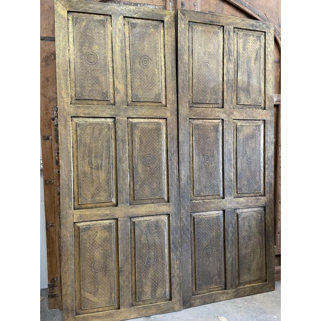 Elevate your interiors with this vintage brass cladded carved barn door, a striking fusion of artisan craftsmanship and...