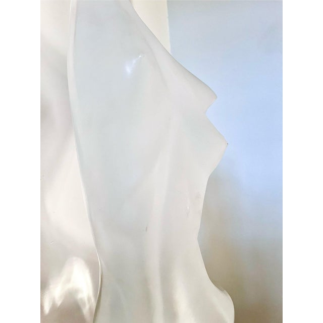 A striking abstract female nude by Michael Shacham, featuring a translucent sculptural form set atop a pink crystal-like...