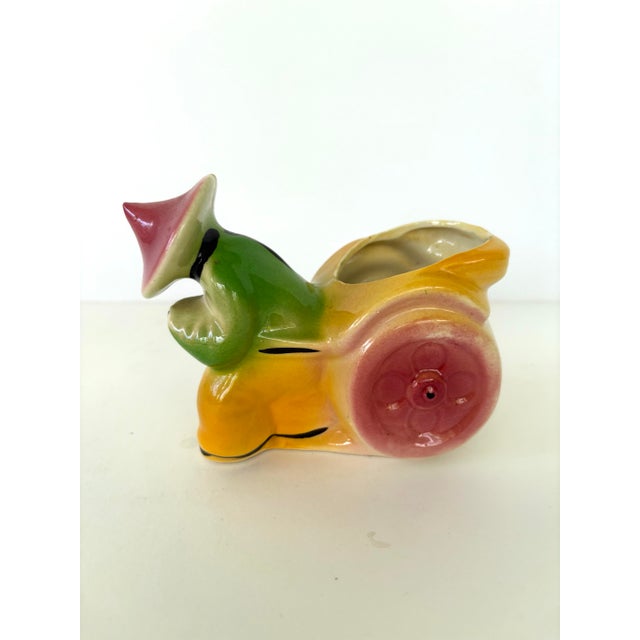 This charming vintage pottery planter set features two stylized Dutch girl figures and a whimsical Chinese man with a...