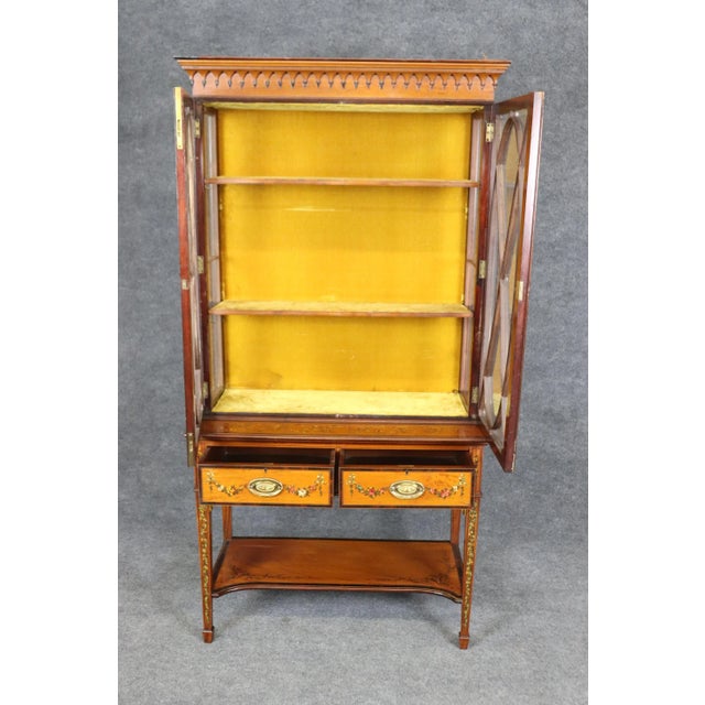 This fine Edwardian Adams era walnut and satinwood inlaid vitrine, circa 1900, is a superb example of English...