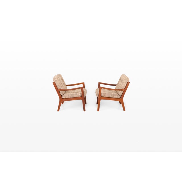 Pair of Danish mid-century modern easy chairs designed by Professor Ole Wanscher for France & Son, Denmark. Crafted with...
