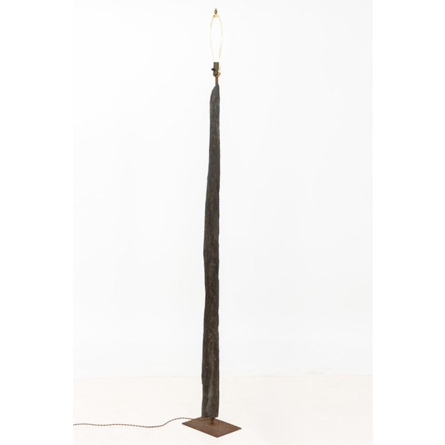 Petrified Wood Floor Lamp, mounted on rectangular iron base. 84.5" H x 10.75" W x 7" D. Provenance: From a One Central...