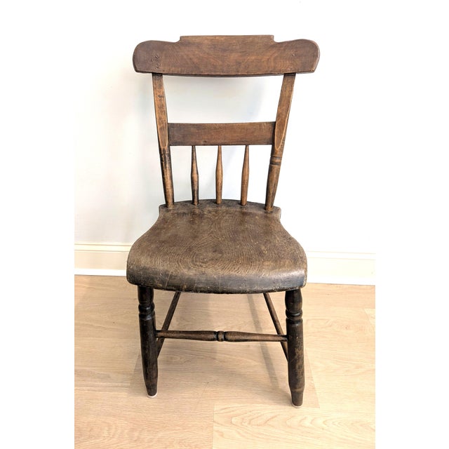 This is a primitive 19th Century farmhouse kitchen chair, which has a half-spindle back and plank seat. These chairs were...