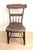 This is a primitive 19th Century farmhouse kitchen chair, which has a half-spindle back and plank seat. These chairs were...