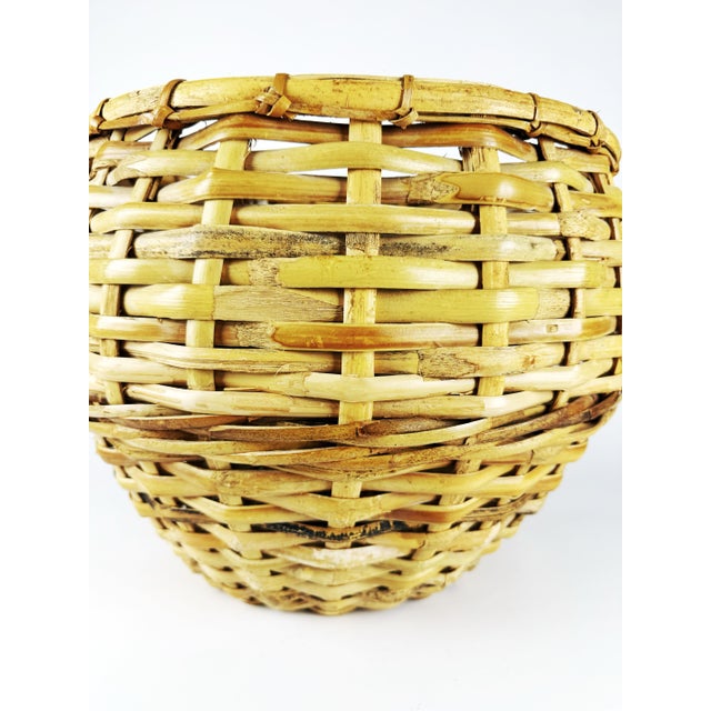 Extra-large vintage handwoven reef basket featuring a classic flared form and beautifully aged honey-toned patina. Crafted...