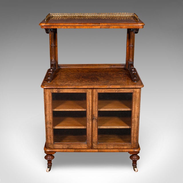 This is an antique pianist’s lounge server. An English, burr walnut display cabinet with buffet form, dating to the early...
