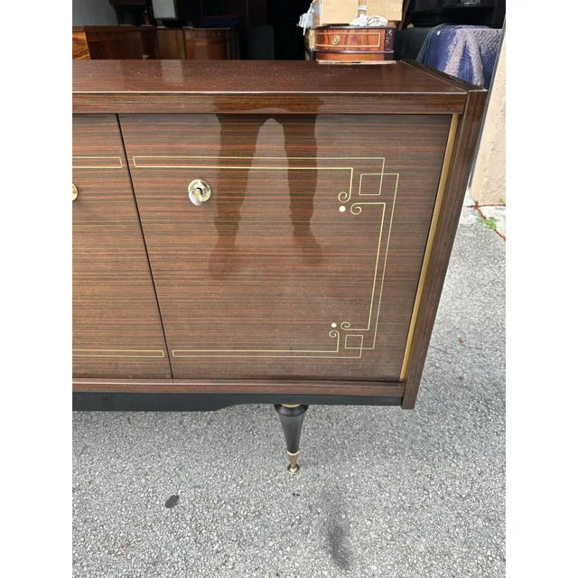 French Art Deco exotic Macassar ebony mother-of-pearl sideboard circa 1950s. 4 doors sideboard, bar area one drawers plus...