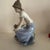 This beautiful Nao by Lladro figurine depicts a young woman with a puppy, embodying love and sweetness in its design....