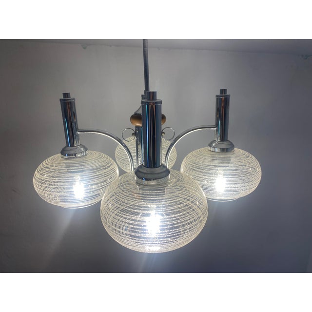 This original 1970s chandelier was produced by emi poljčane in slovenia, then part of yugoslavia. The design combines...
