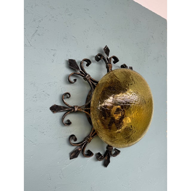 Vintage ceiling light made in Italy in the 1960s. Wall lamp in metal and amber-colored glass. The round lampshade is made...