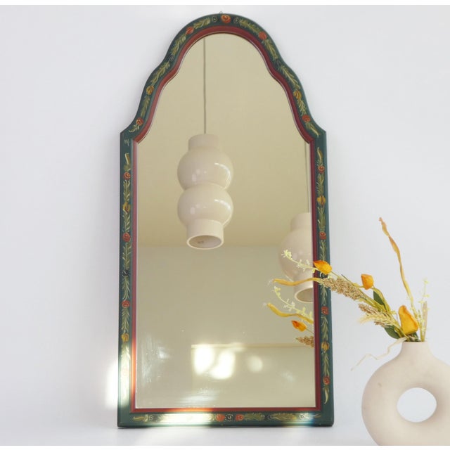 A Dutch scalloped mirror made out of wood. A beautiful vintage wall mirror hand painted in green and red with floral...