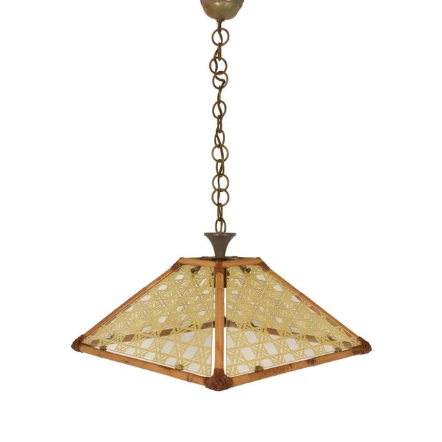 Chandelier in textured glass, rattan, bamboo and brass. Pendant Italy, 1970s. Up to 250V (Europe/UK Standard).The wiring...