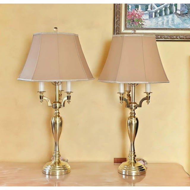 Pair of tall elegant contemporary candelabra styled brass table lamps with 4 arms (3 arms around a central arm). They are...