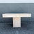 This striking vintage side table showcases the timeless elegance of solid polished travertine in a bold architectural...