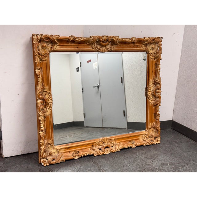 Design Plus Gallery presents a Neoclassical Empire Style Wall Mirror. The frame showcases carved scrollwork, shell motifs,...