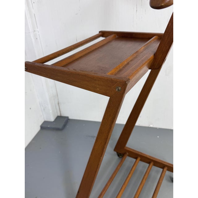 A beautiful Modernist dressboy. with a beautiful wooden MCM Zig Zag design with brass bolts and wheels. Made in the 1950s...
