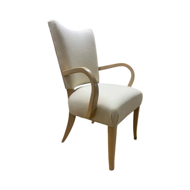 This is the Root Beer chair by Brueton. It is done in a cream white fabric with solid maple legs and arms. The hardwood...