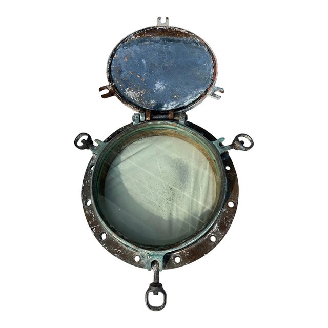 Heavy duty cast bronze maritime vessel’s porthole with original port light glass and cast iron lid still intact having...