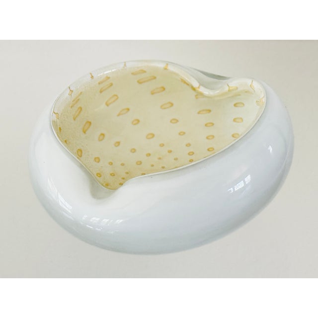 A glass ashtray with a Sommerso white layer and a beige and gold interior. Attributed to Alfredo Barbini. Italian from the...