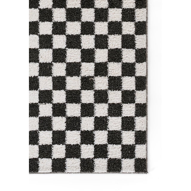 A modern classic is always in style. Part of the Kaia Collection, this playful black and white check rug has been updated...