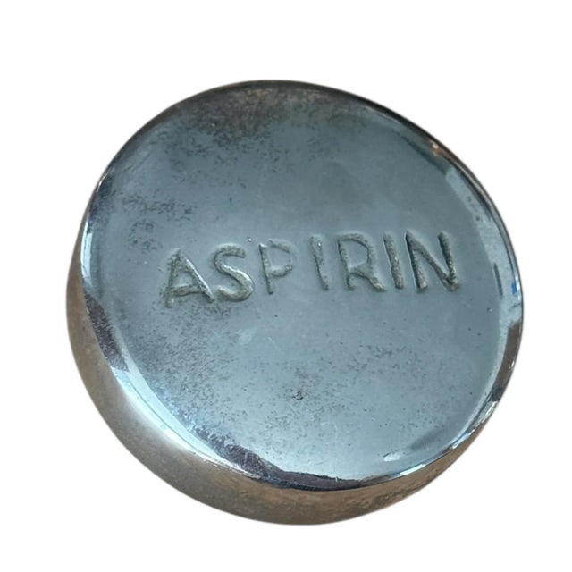 This is a vintage paperweight stamped Aspirin. It has a great weight and low profile. Perfect mid century accent for your...