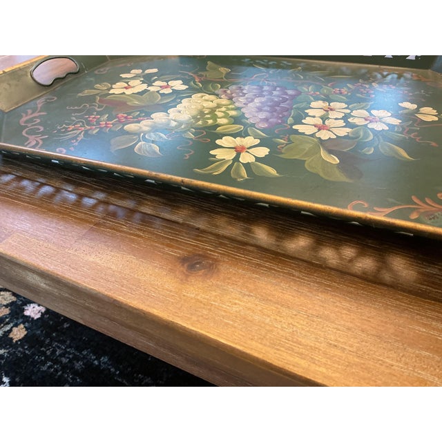 An exceptional mid-century hand-painted metal tôleware serving tray featuring a deep hunter-green finish and a hand-...