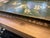 An exceptional mid-century hand-painted metal tôleware serving tray featuring a deep hunter-green finish and a hand-...