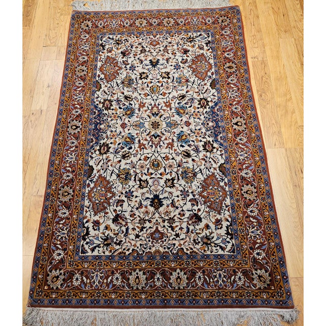 "This elegant vintage Persian Isfahan area rug, hand-knotted in the third quarter of the 20th century on a silk...