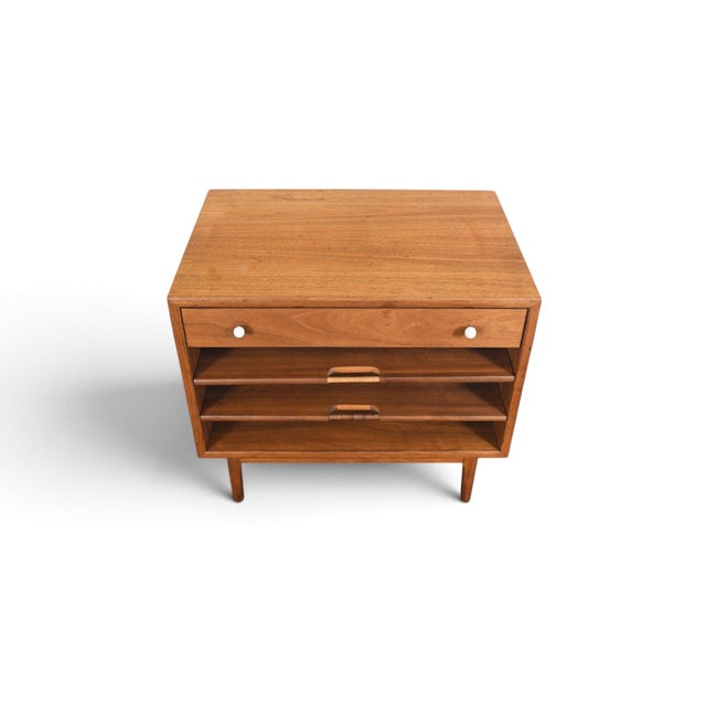 This "Declaration" magazine side table was designed by Kipp Stewart for Drexel in the USA during the 1960s. The walnut...