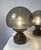 Elegant pair of vintage Italian table lamps featuring glass shades in smoked seeded glass on a solid wooden base. The...
