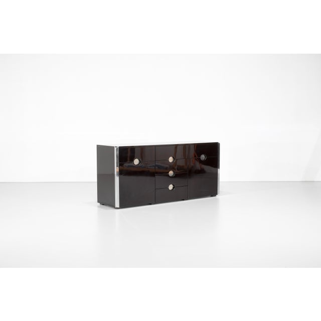 "MB3" model sideboard in chocolate brown lacquered wood with chrome metal trim. Designed by Luigi Caccia Dominioni for...