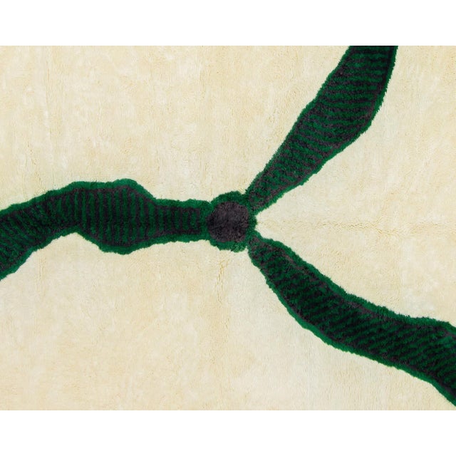 Ideal Hand-knotted rug showcasing an Ivory backdrop enhanced with a captivating abstract pattern, outlined by Midnight...