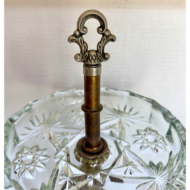 Here is a striking vintage Hollywood Regency ashtray stand, likely dating to the mid-20th century, featuring a beautifully...