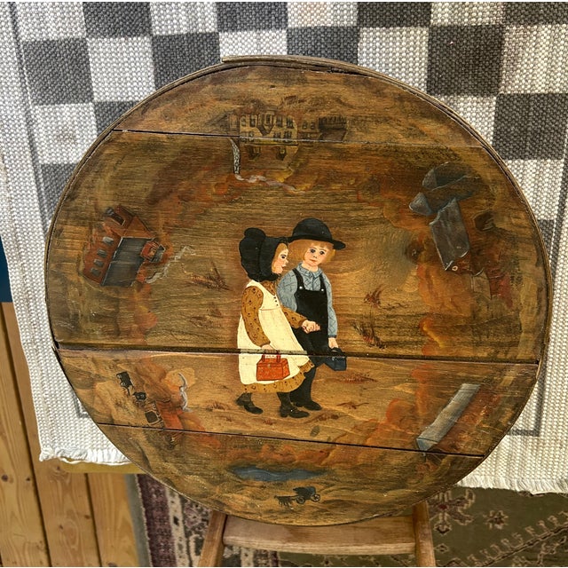 Charming vintage American folk-art cheese box featuring a beautifully hand-painted pastoral scene of a courting couple in...