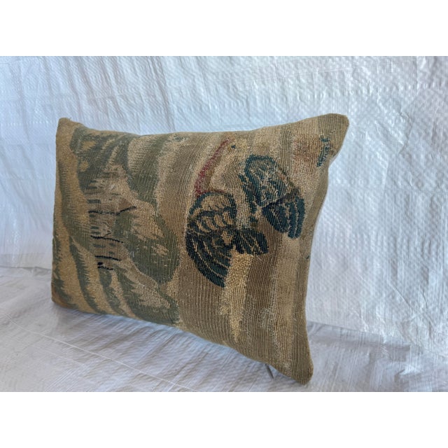 17th century Flemish tapestry pillow made from an authentic handwoven wool tapestry fragment. The textile features a...