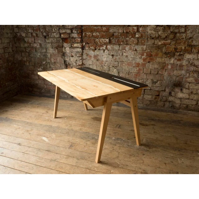 The designer's take on a design classic adapted for modern living. The inkwell not only looks great but acts as cable...