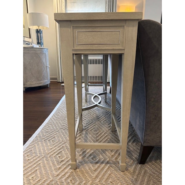 Bernhardt heather gray wood console table with stainless steel inlay outlining the three drawers. Can be used in living...